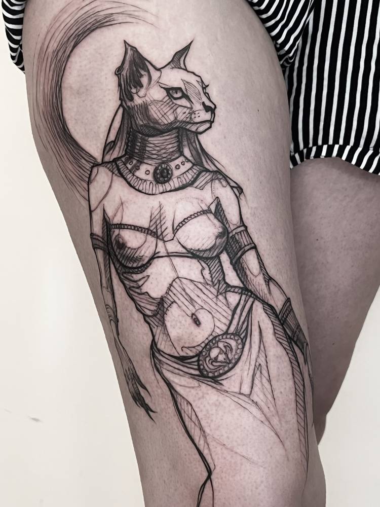 Bastet tattoo in sketch work style located on the thigh.