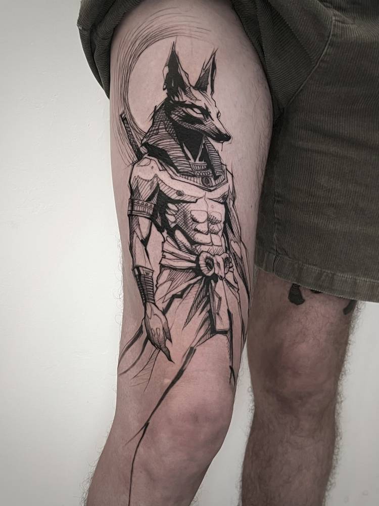 Anubis tattoo in sketch work style done on the thigh.