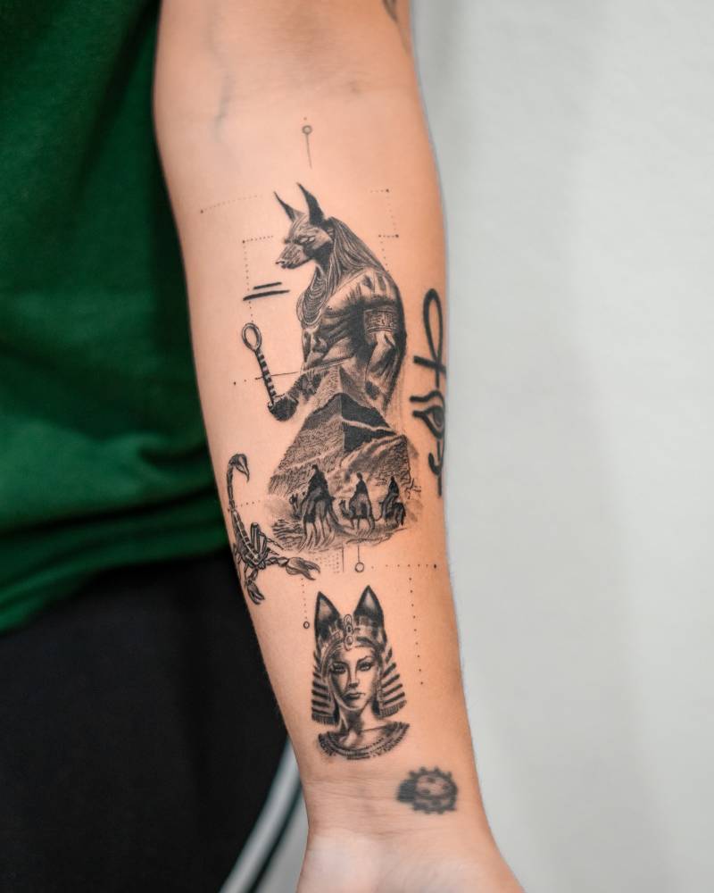 Graphic style Egyptian themed tattoo with Anubis and a pharaoh placed on the inner forearm.
