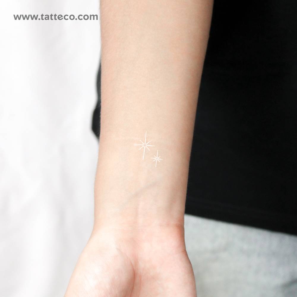 White shinning stars temporary tattoo located on the wrist.