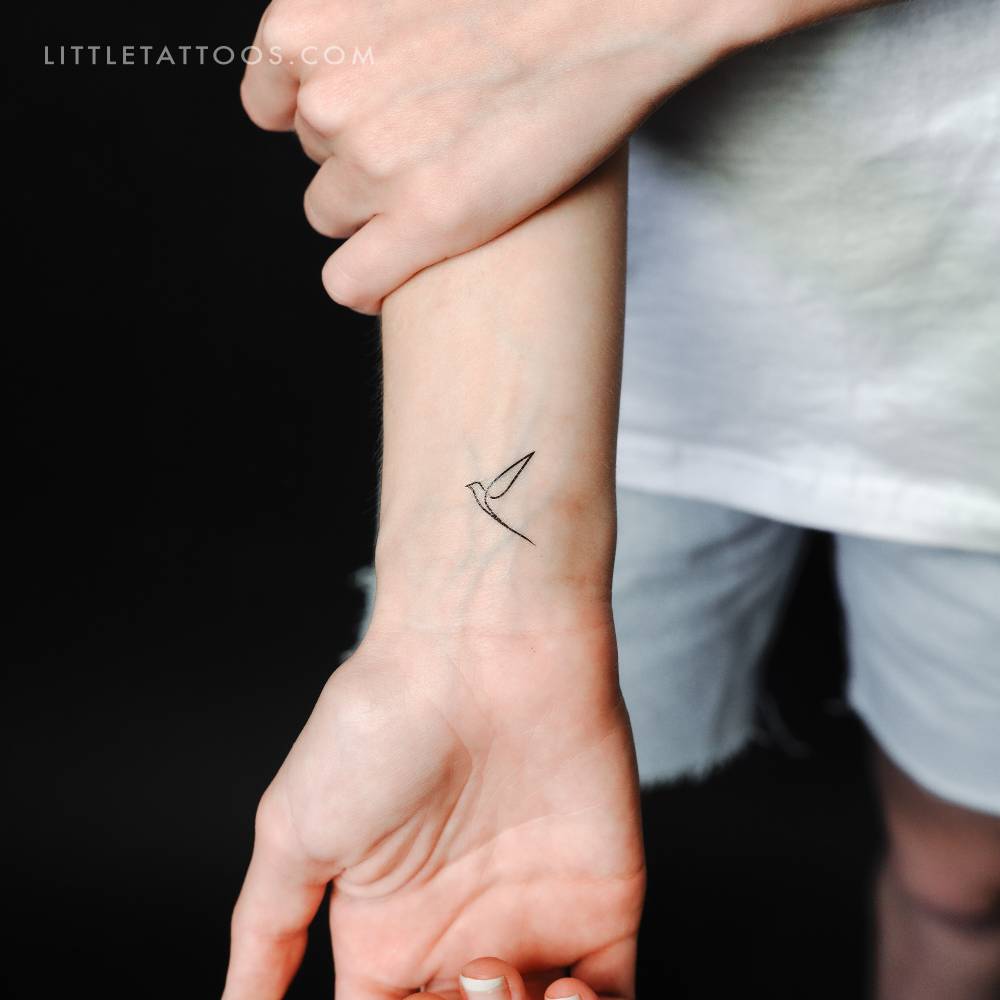 Single line bird temporary tattoo located on the wrist.