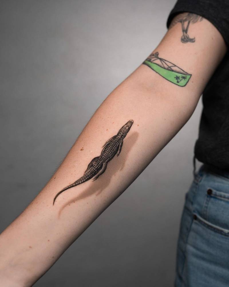 Micro-realistic style alligator tattoo located on the inner forearm.