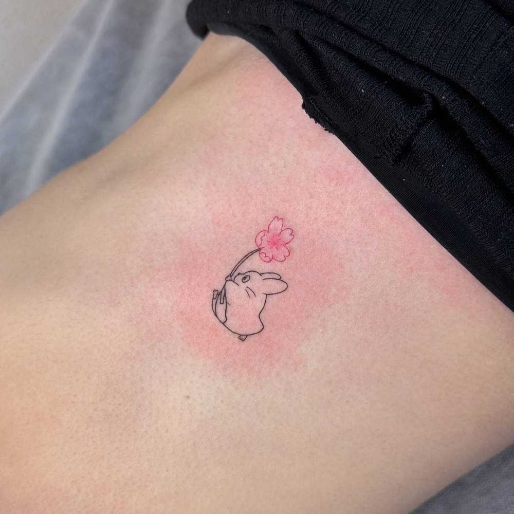 Fine line style Chuu Totoro tattoo located on the rib.