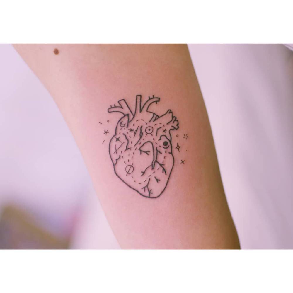 Anatomical heart map tattoo in illustrative style located on the forearm.