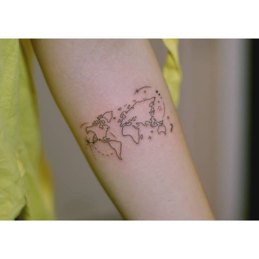 World map tattoo in fine line style located on the inner forearm.