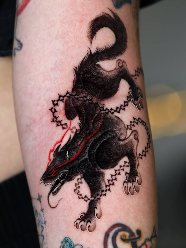 Beast of Darkness from 'Berserk' tattooed on the inner forearm.