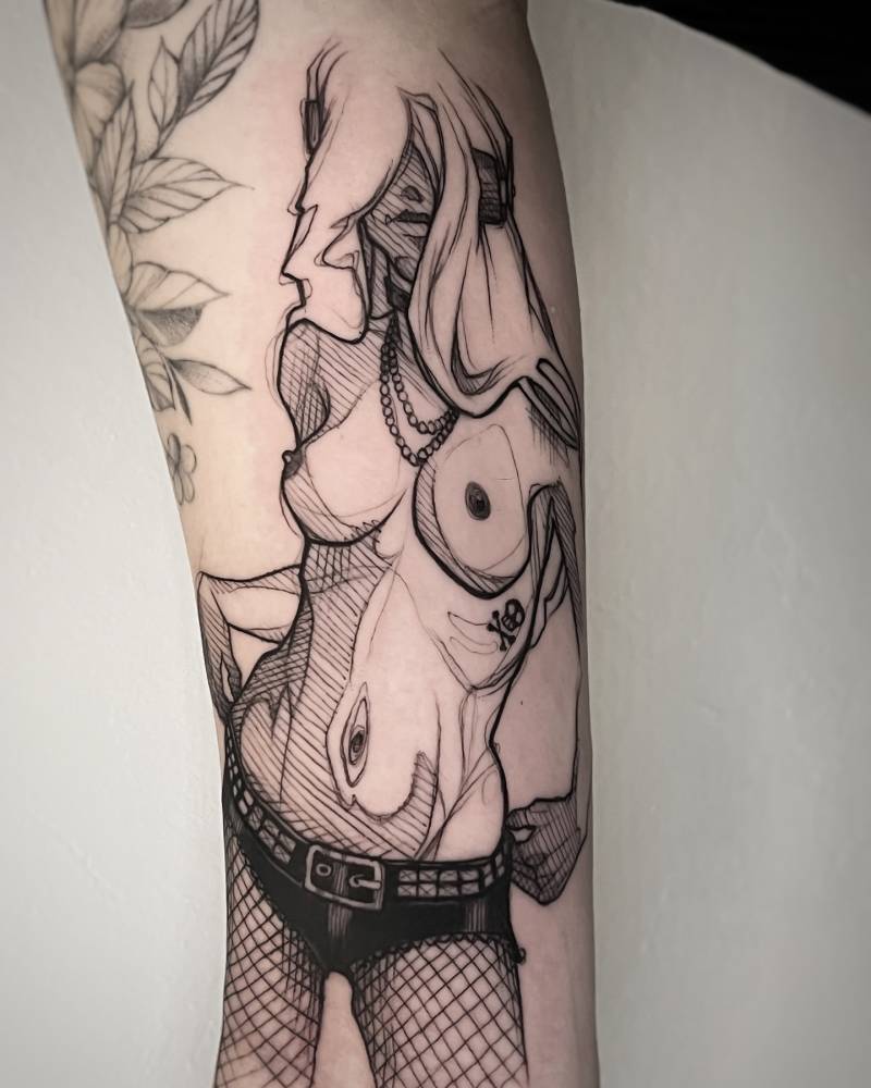 Nude woman tattoo in sketch work style placed on the inner arm.