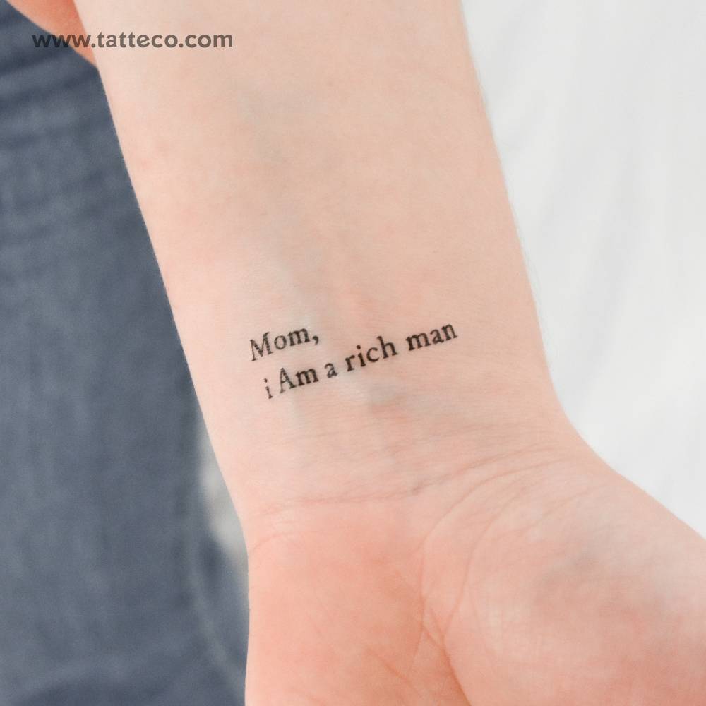"Mom, I am a rich man" temporary lettering tattoo located on the wrist.