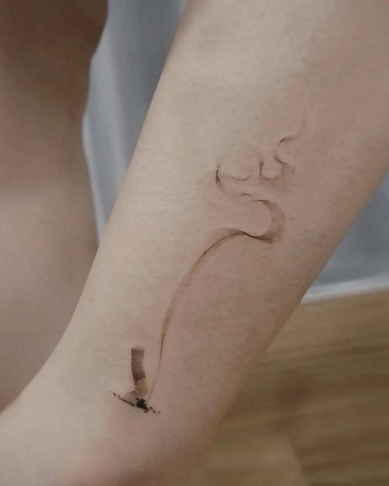 Hand poked cigarette tattoo located on the ankle.