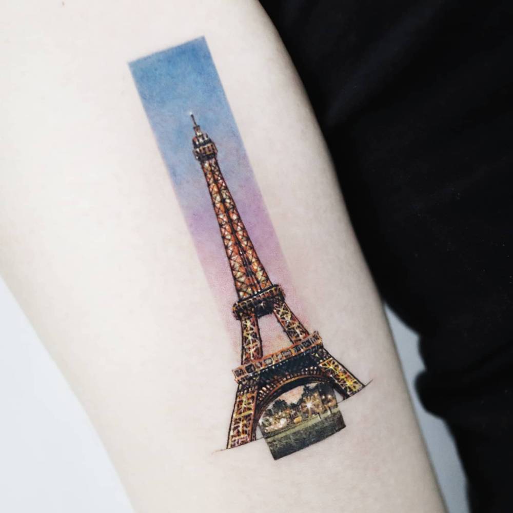 Eiffel Tower tattoo placed on the inner forearm, done in micro-realistic style.
