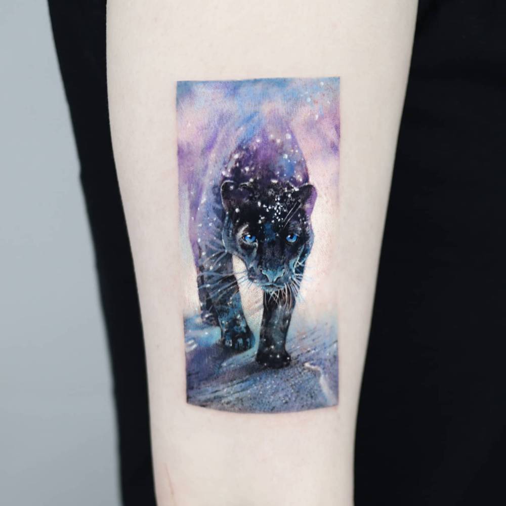 Micro-realistic style black panther tattoo located on the inner forearm.