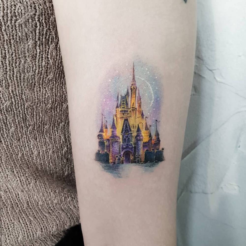 Disney Castle tattoo located on the inner forearm, micro-realistic style.