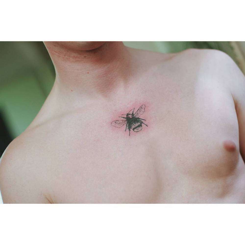 Illustrative style bee tattoo located on the chest,