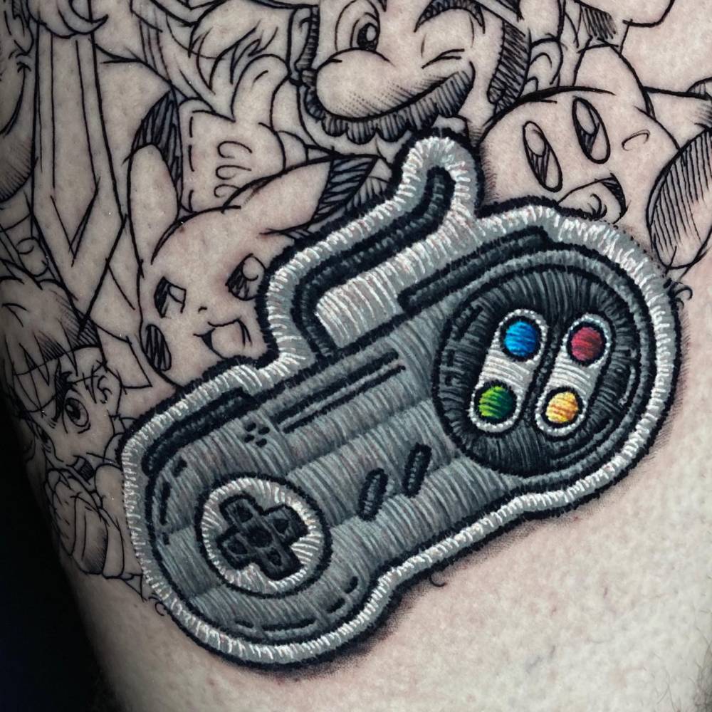 Nintendo themed tattoo located on the thigh.
