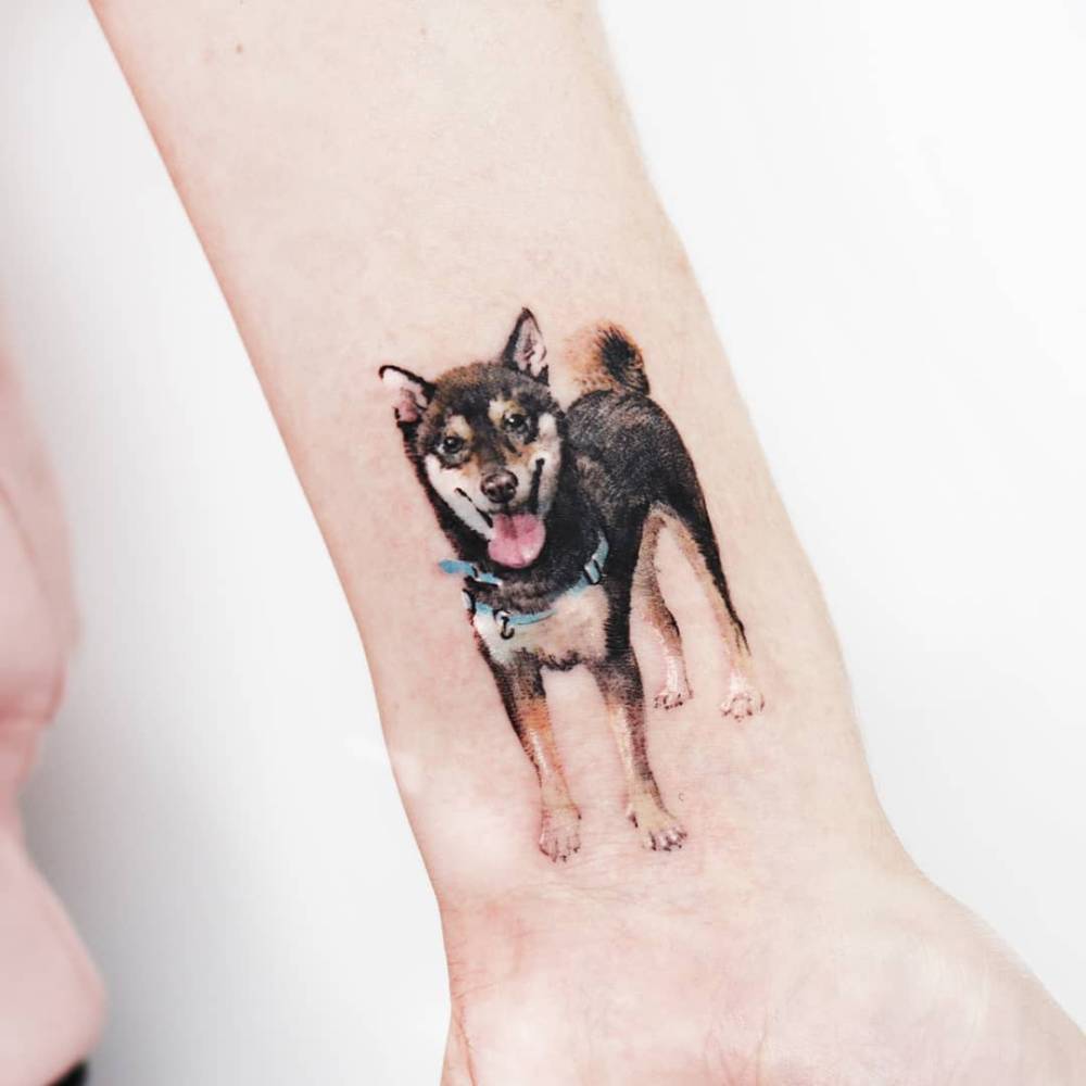 Shiba Inu tattoo in micro-realistic style located on the wrist.