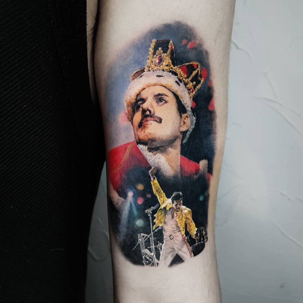 Freddie Mercury portrait tattoo in micro-realism located on the bicep.