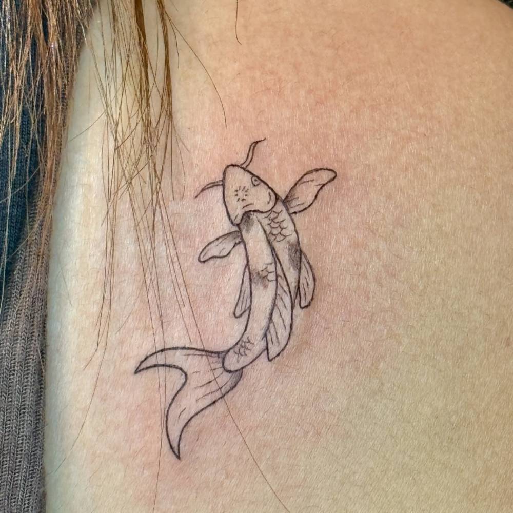 Koi fish tattoo in illustrative style located on the shoulder.