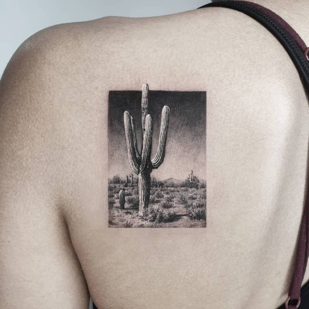 Desert landscape tattoo placed on the shoulder blade.