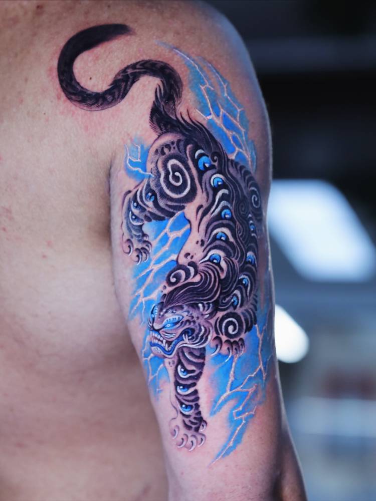 Tiger tattoo in Japanese style located on the tricep.