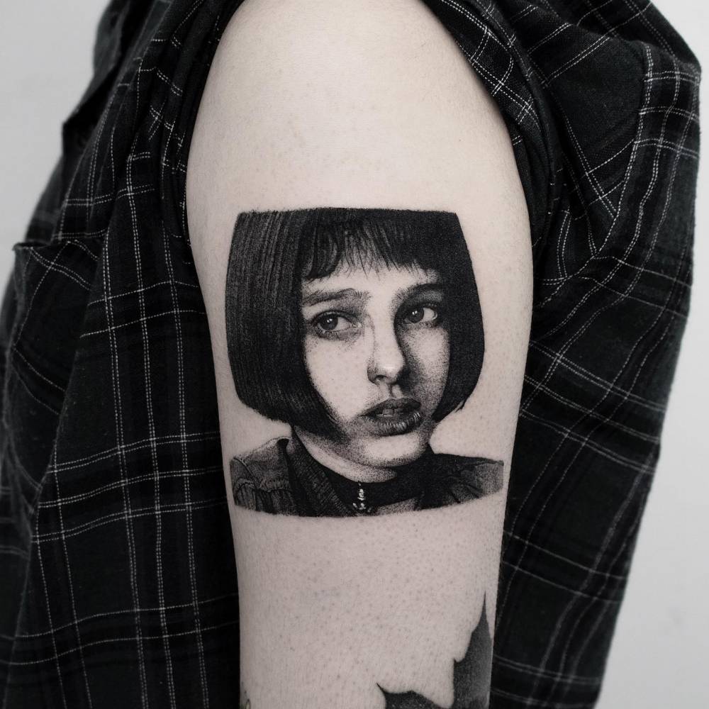 Mathilda Lando portrait tattoo located on the upper arm.
