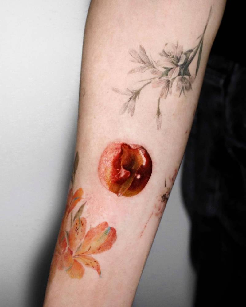 Peach tattoo placed on the inner forearm.