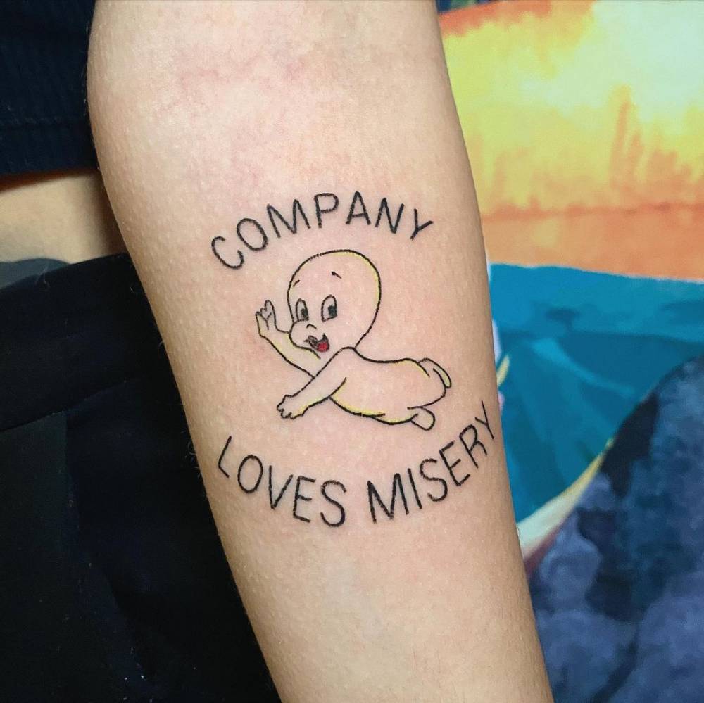 Casper and "company loves misery" tattooed on the inner forearm.