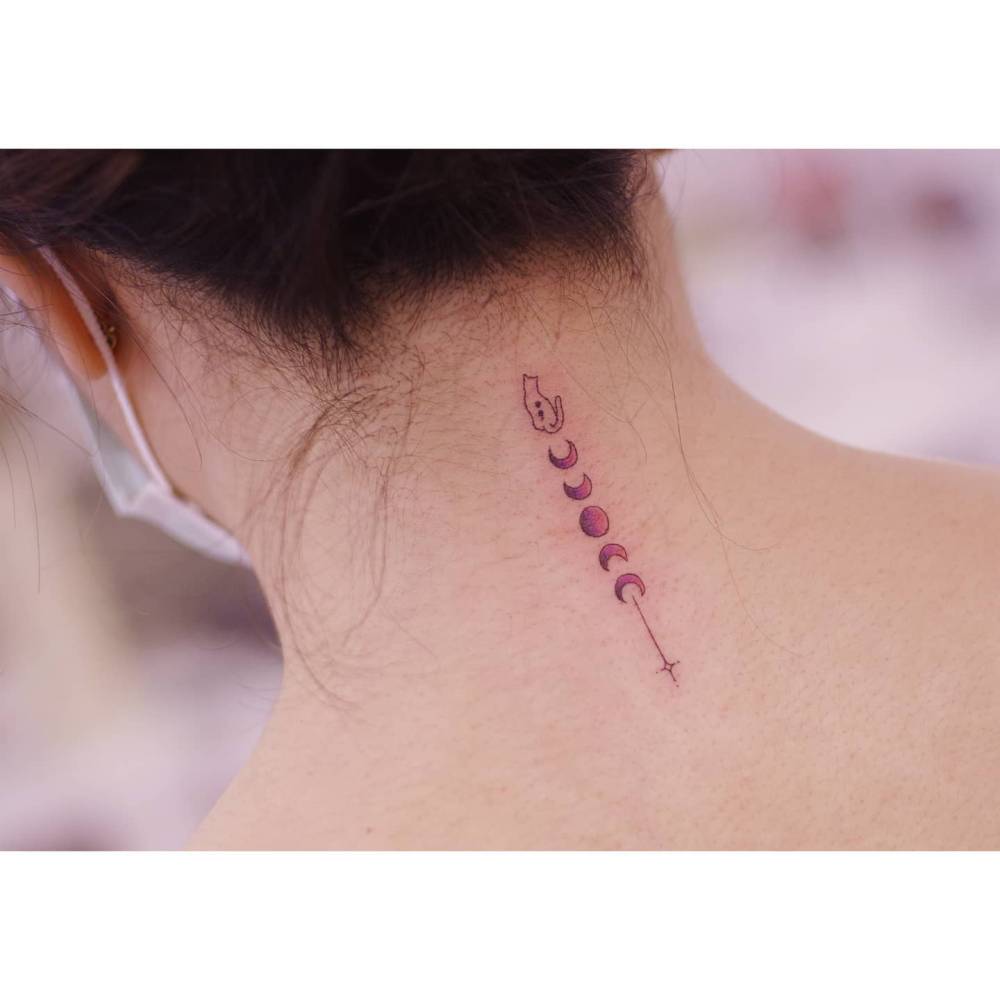 Moon phases tattoo in  illustrative style located on the back of the neck.