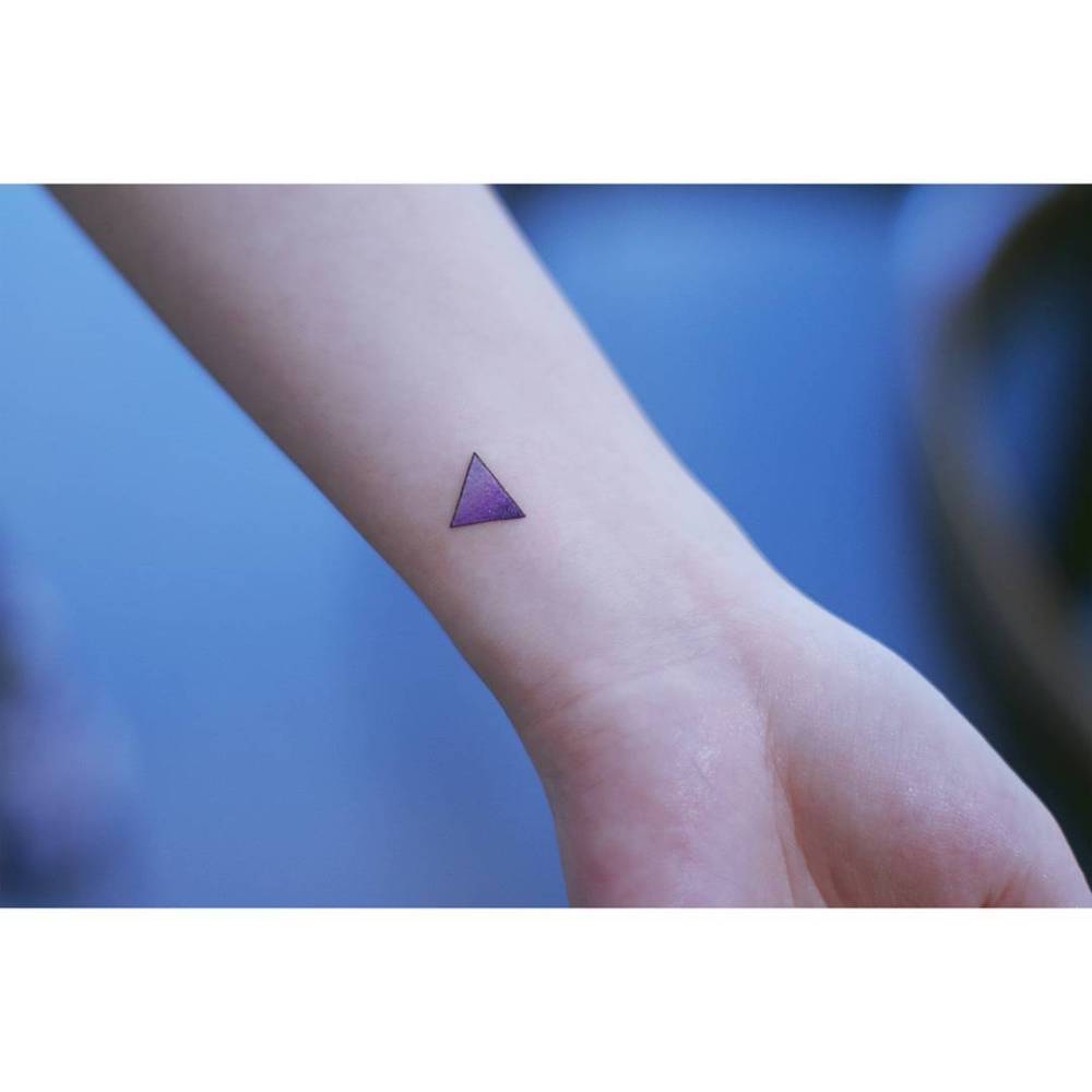 Spectrum triangle tattoo located on the wrist.