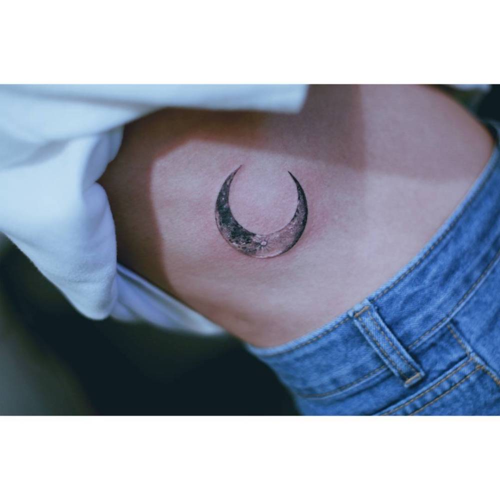 Crescent moon tattoo in illustrative style done on the waist.