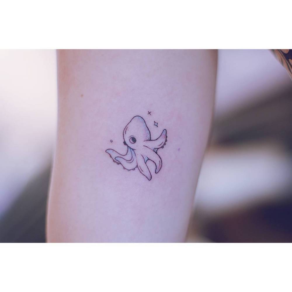 Cute little octopus in cartoon style tattooed on the inner arm.