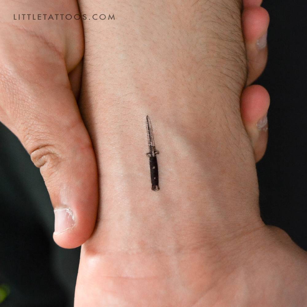 Stiletto automatic knife temporary tattoo located on the wrist.