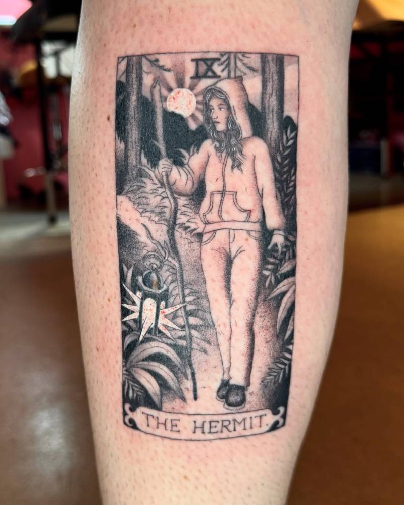 Hermit tarot card tattoo located on the calf, illustrative style.