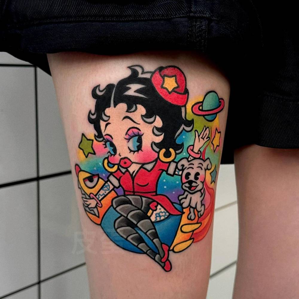 Cartoon style Betty Boop tattoo placed on the thigh.