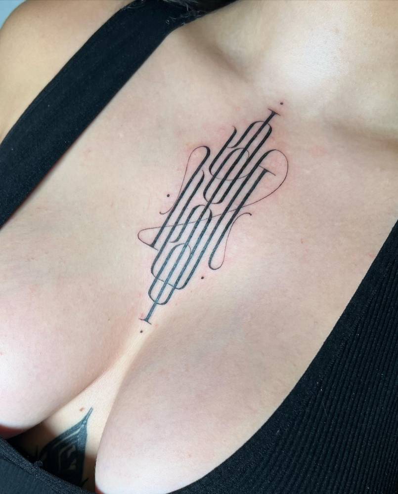 Monogram tattoo located on the sternum.