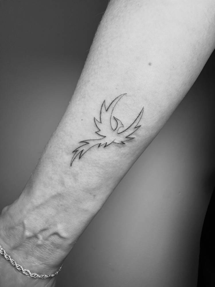 Phoenix tattoo in fine line style placed on the wrist.
