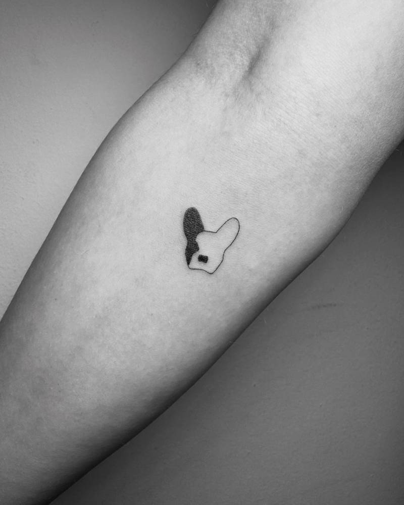 Tiny French Bulldog portrait tattoo in minimalistic style done on the inner forearm.