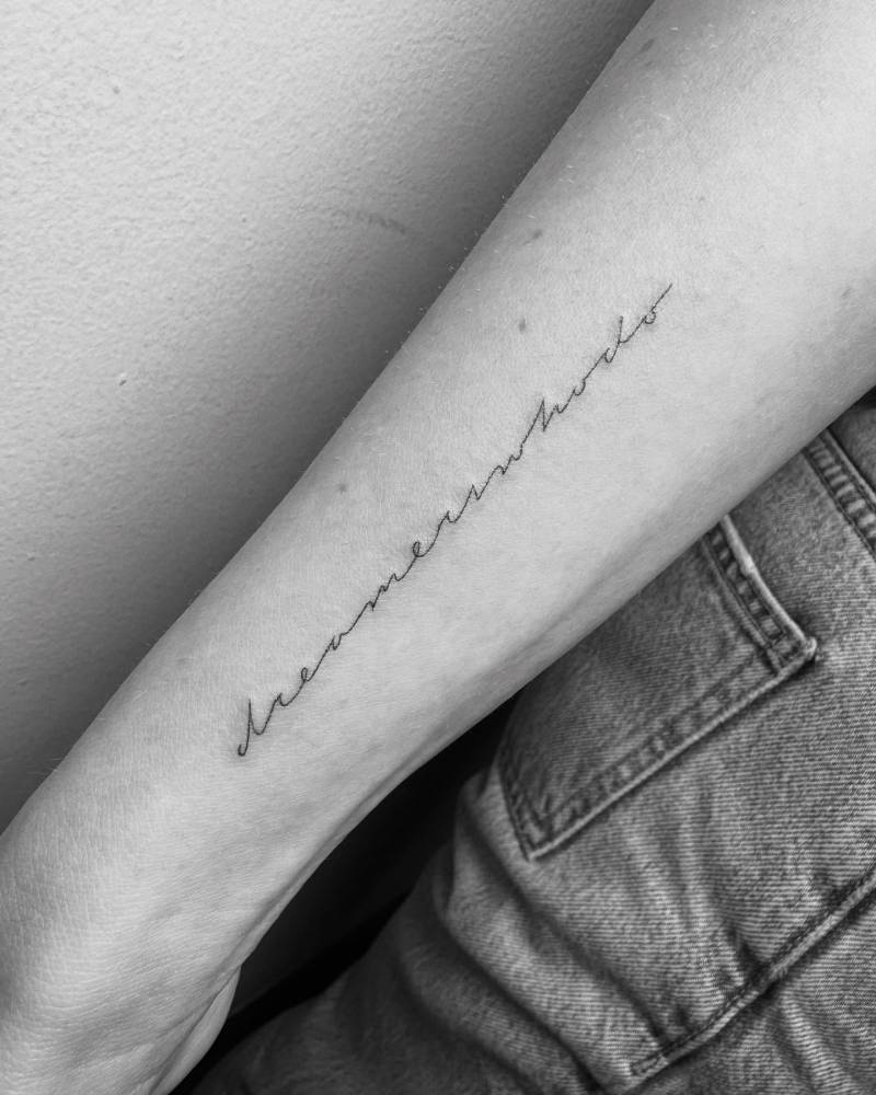 "Dreamers who do" lettering tattoo in handwritten font.