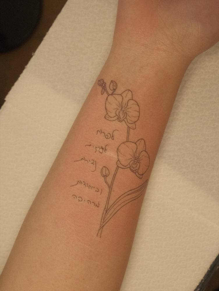 Orchids tattoo in fine line style located on the wrist.