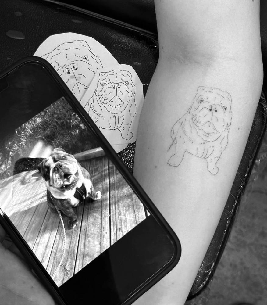 Fine line style Bulldog tattoo in memory of her pet.