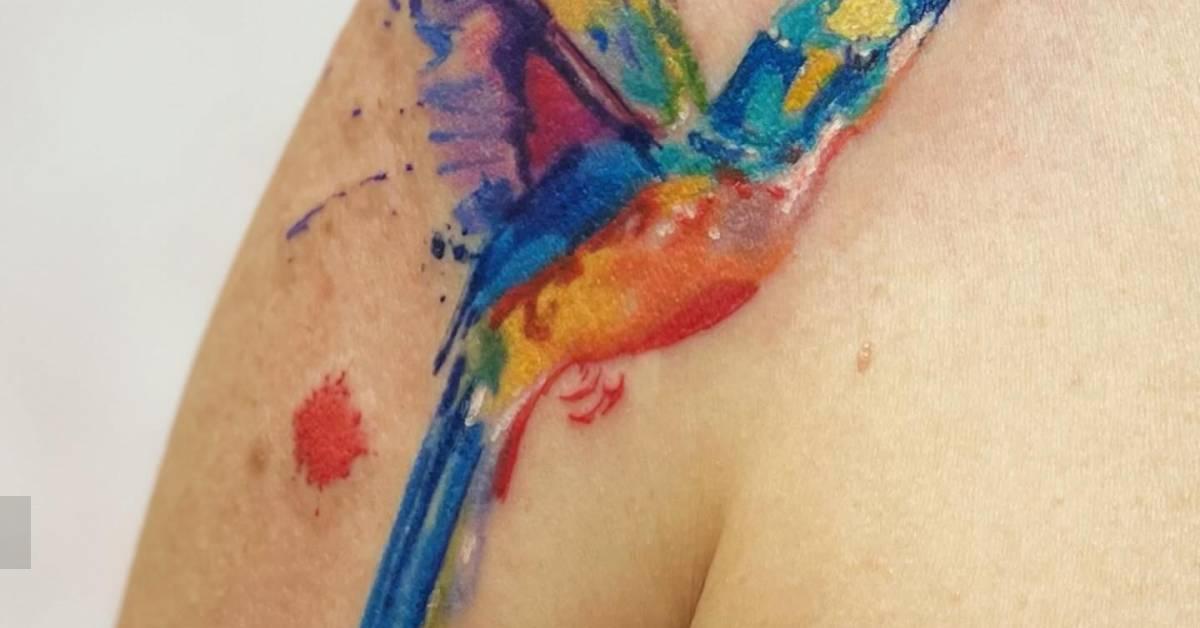 Hummingbird tattoo in watercolor style located on the
