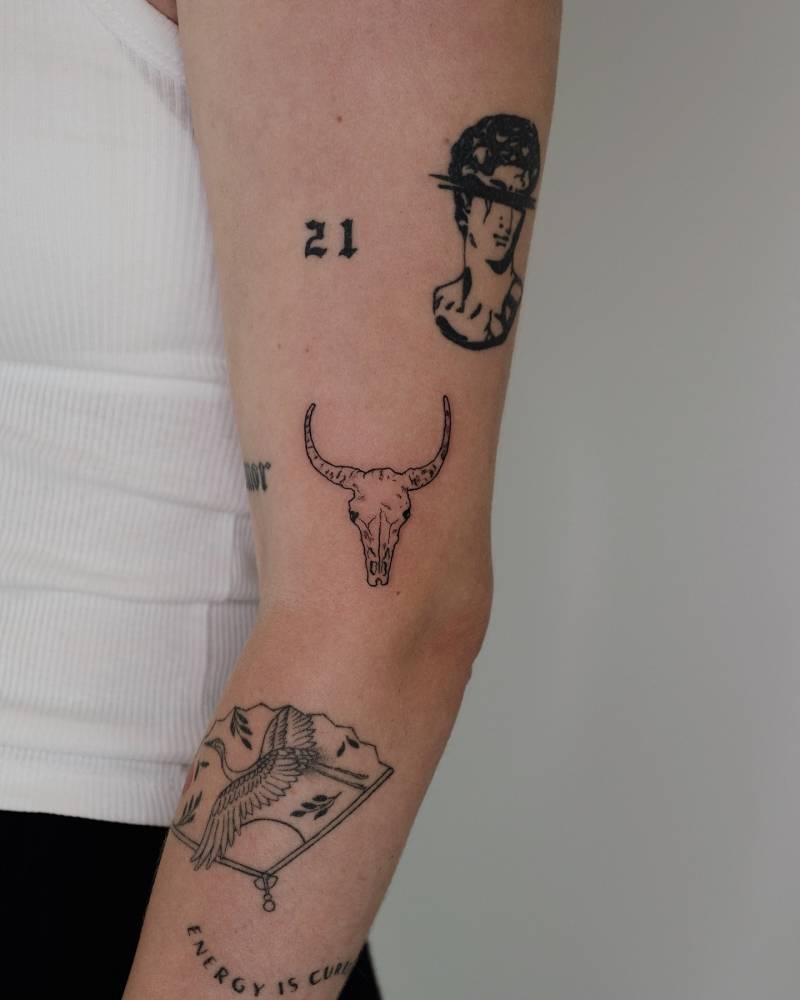 Illustrative style arm composition tattoos.