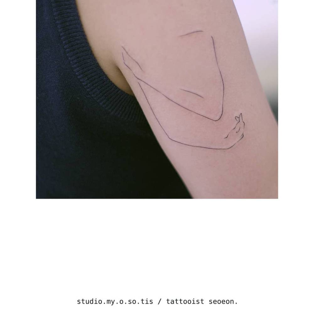 Self hug tattoo in fine line style placed on the upper arm.