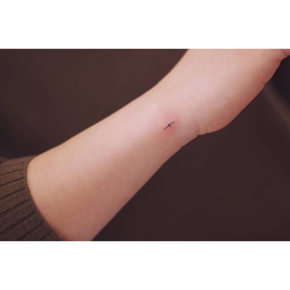 Tiny minimalistic design tattooed on the wrist.