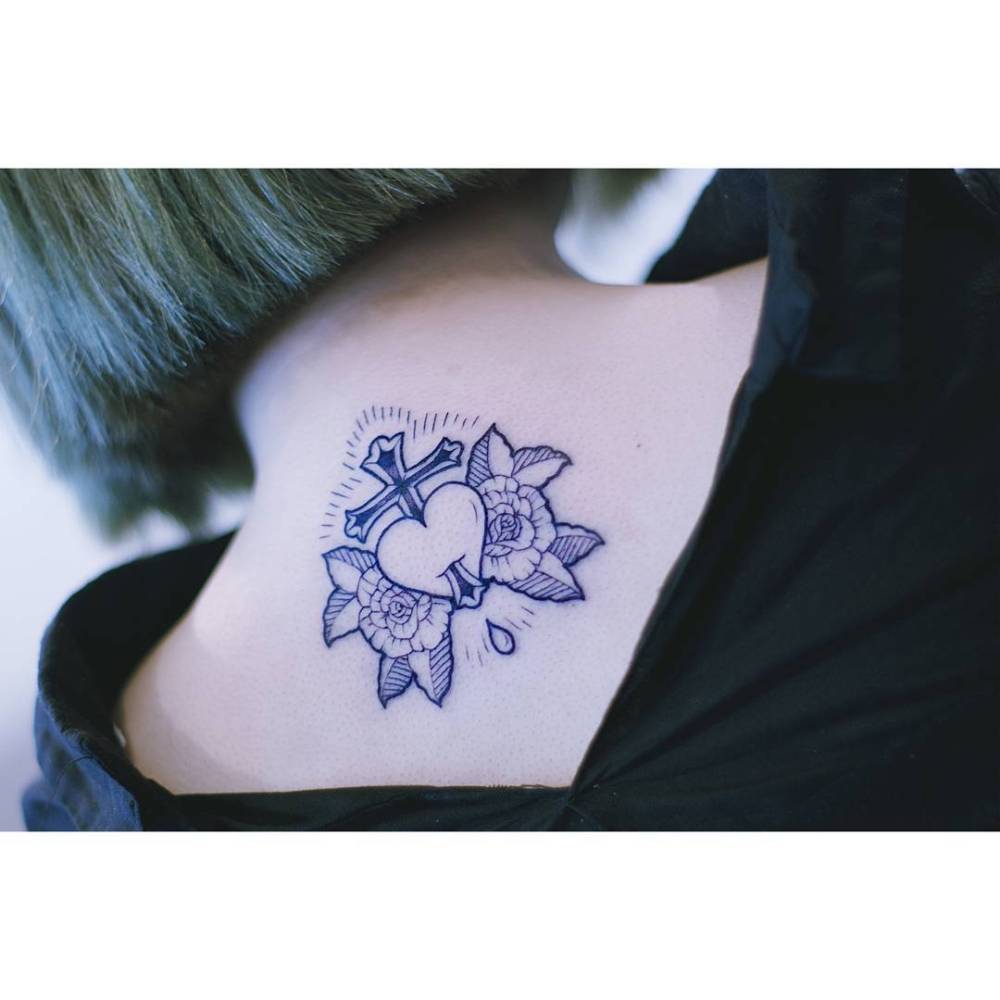 Heart, cross and peonies tattoo located on the upper back.