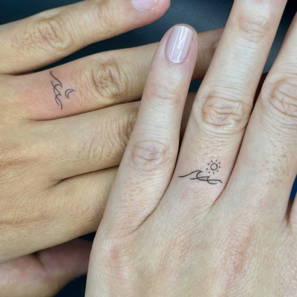 Matching minimalistic sun, moon and wave tattoo for couple.
