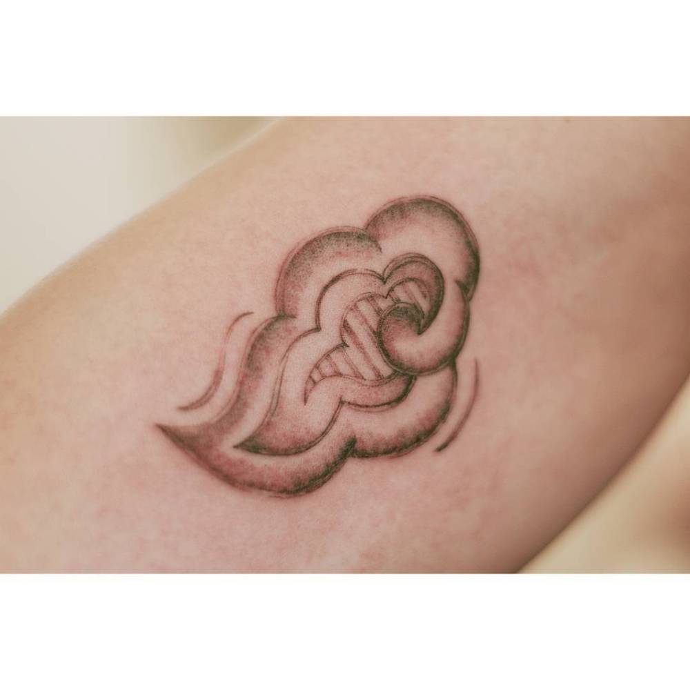 Illustrative style cloud tattoo placed on the inner arm.