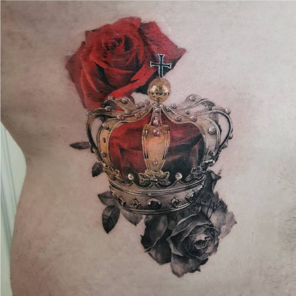 Realistic style crown and roses tattoo located on the waist.