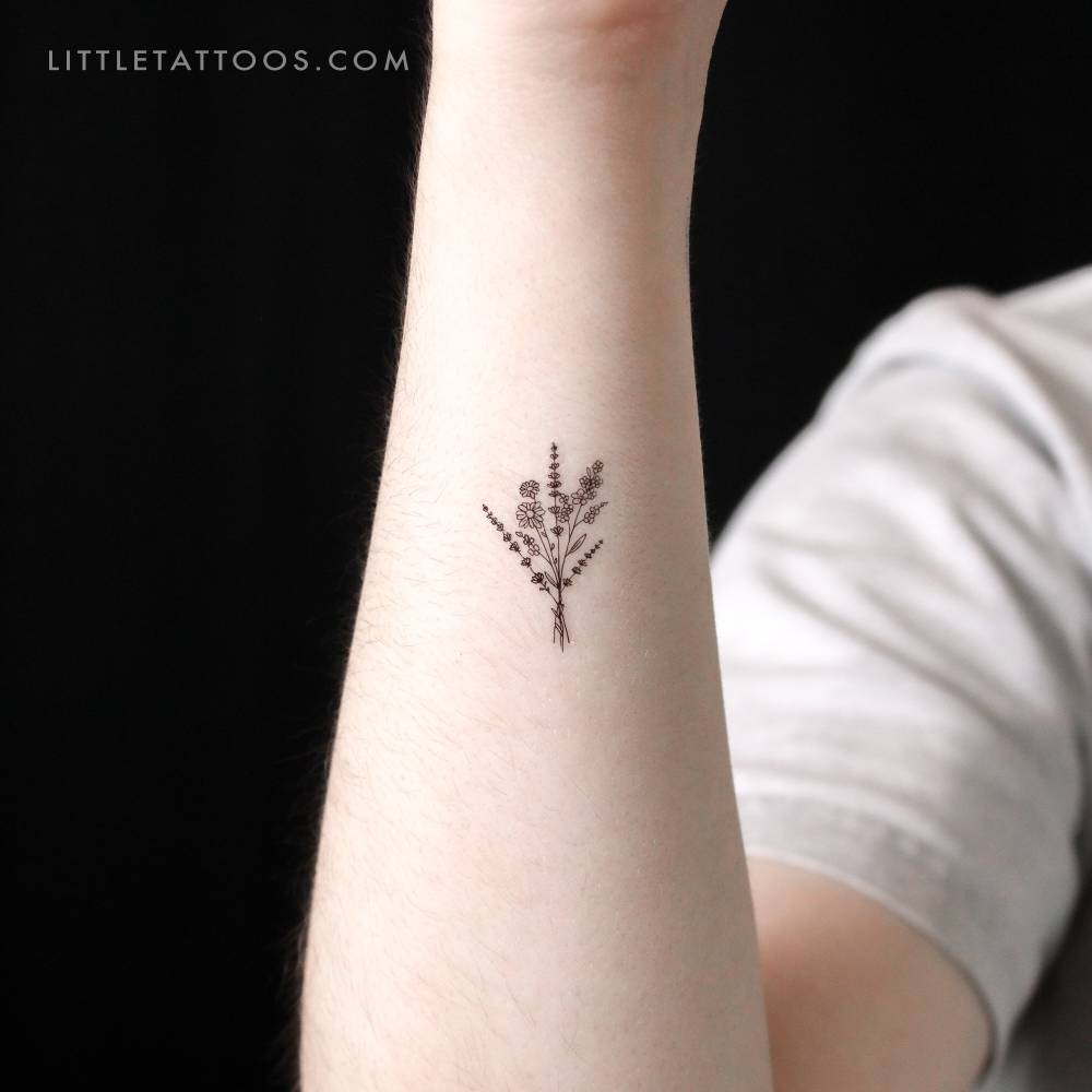 Small wild flower bouquet temporary tattoo located on the wrist.