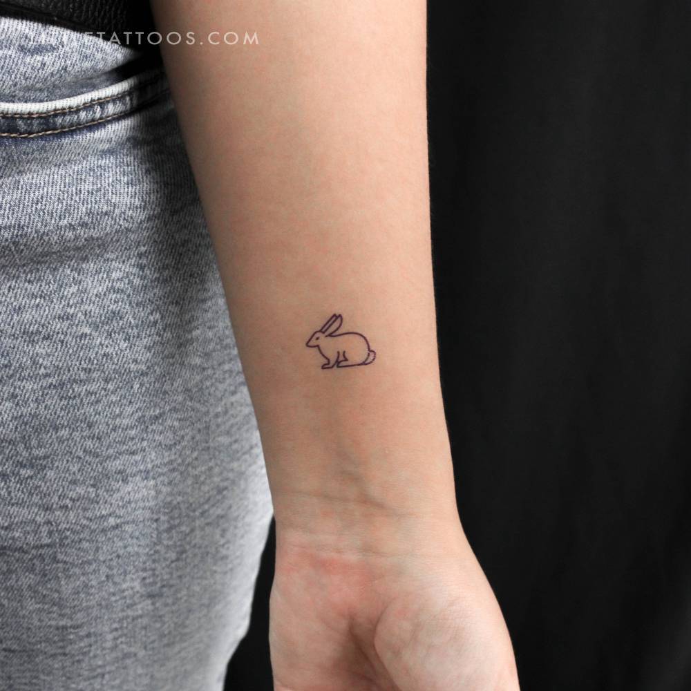Minimalistic style rabbit temporary tattoo placed on the wrist.