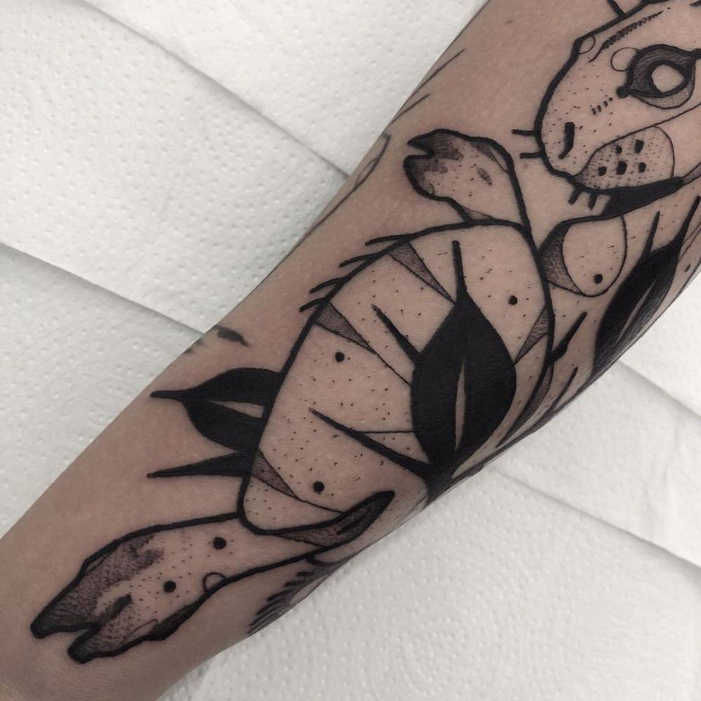 Blackwork rabbit tattoo on the forearm.